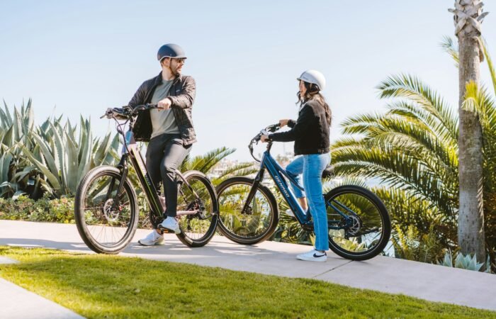 a man and a woman standing next to their bikes