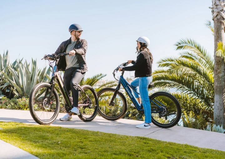 a man and a woman standing next to their bikes