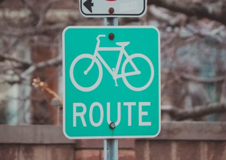 a no parking sign and a bicycle sign on a pole